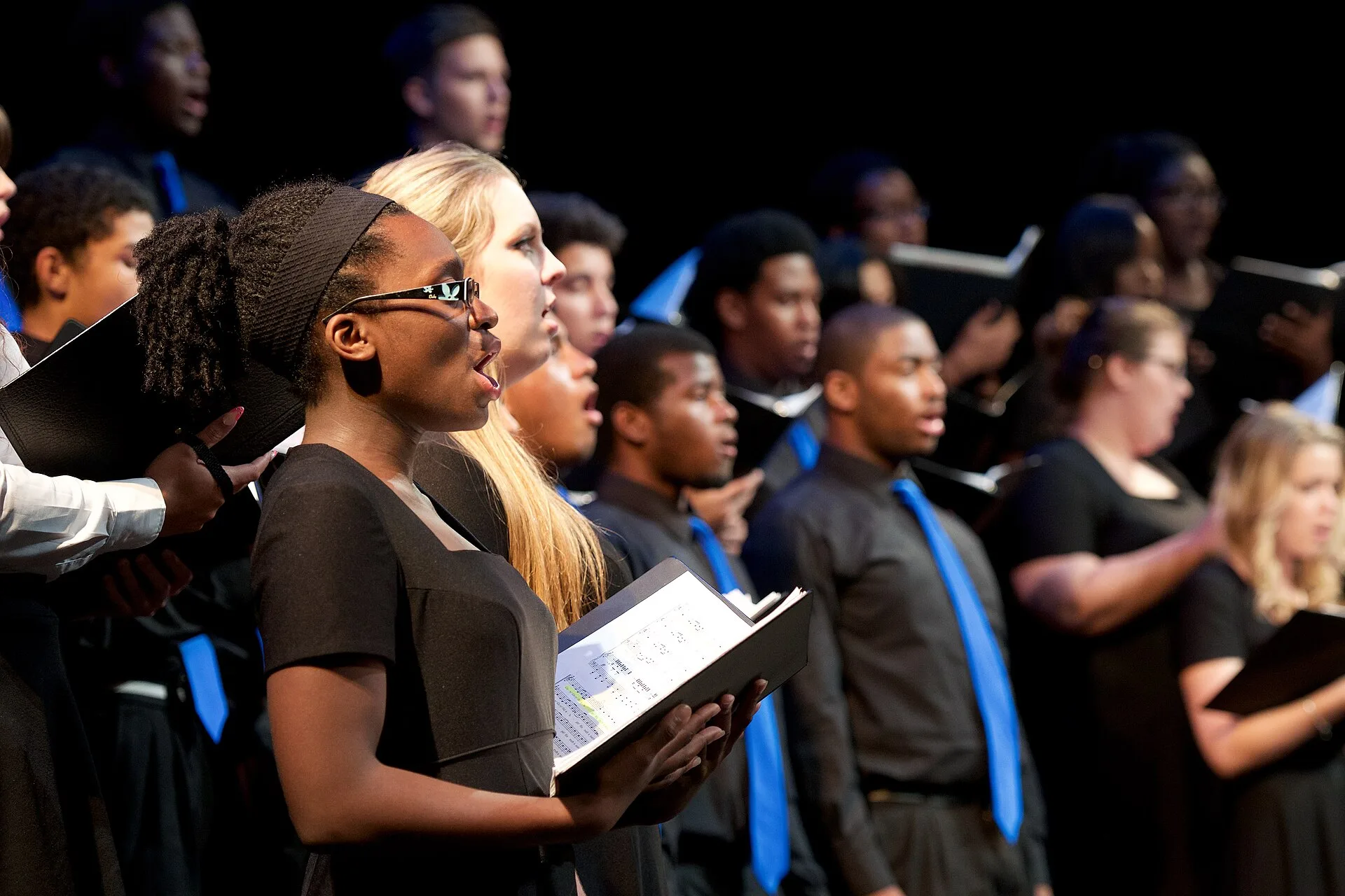 Broward County high school students sing on stage at the Coral Springs Center for the Arts