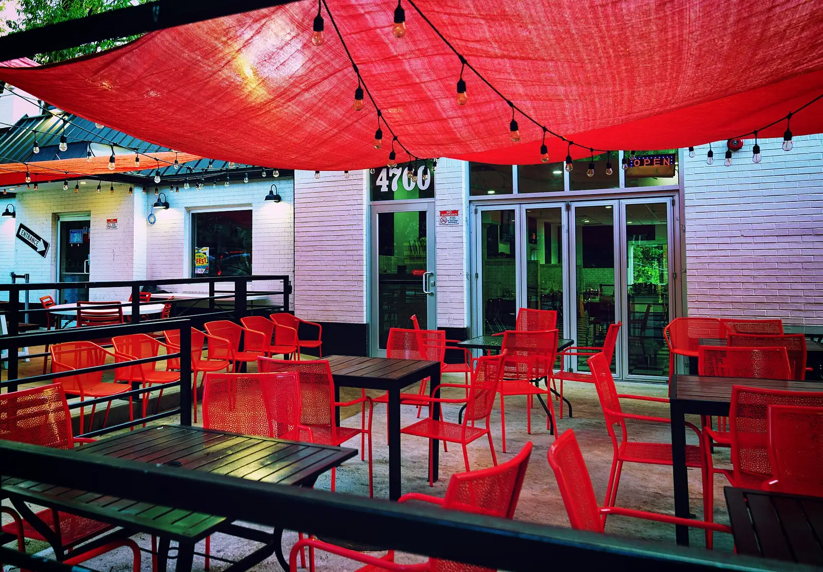 Tables and umbrellas at a sidewalk cafe. The photo was not taken in Coral Springs.