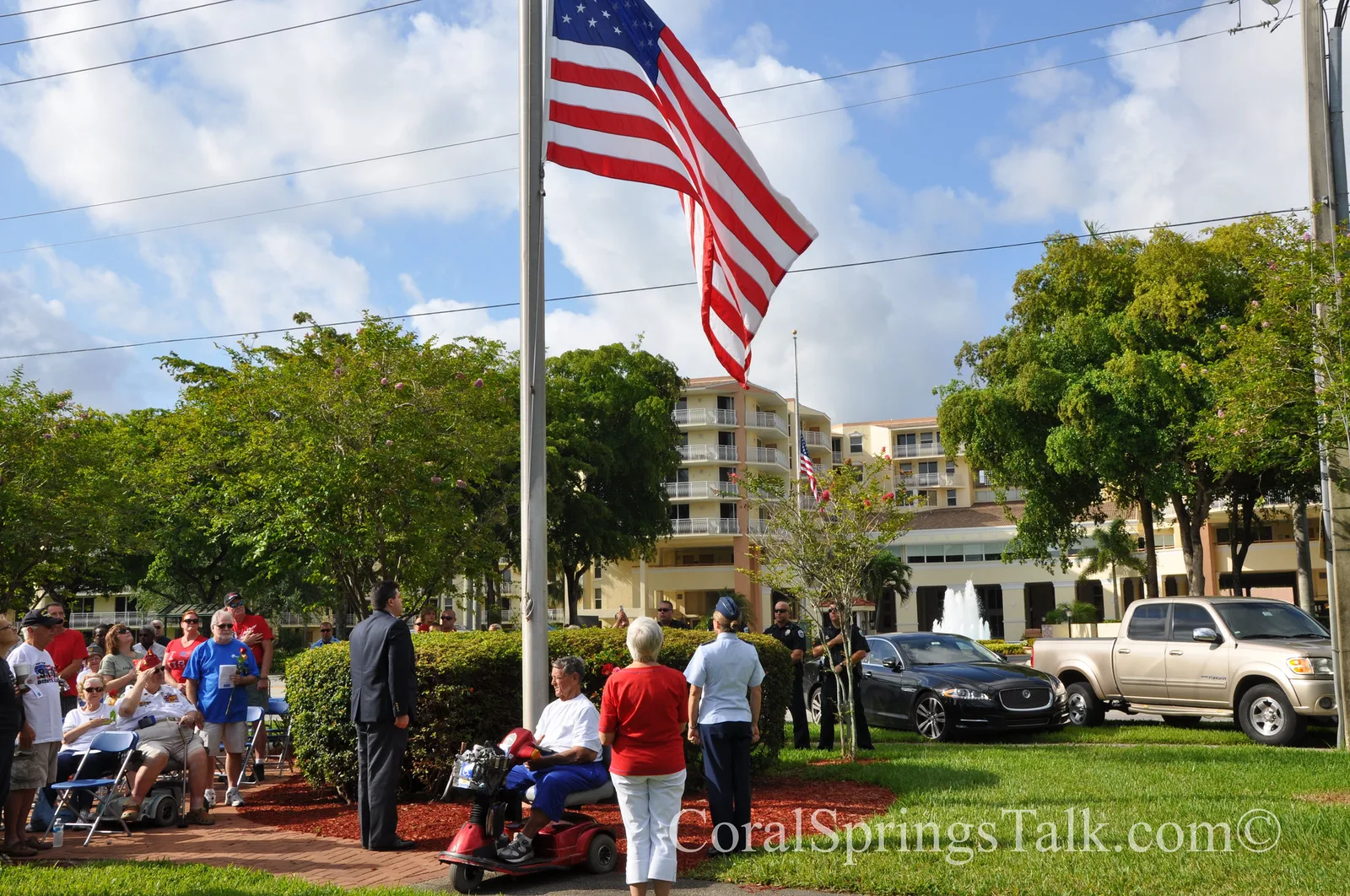 The American flag flies over a ceremony at Veterans Park, Coral Springs, Fla.